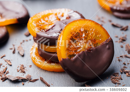 Candied orange slice in chocolate Slate background Candied orange slice in chocolate Slate background 38609802