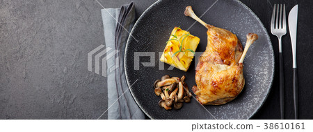 Duck legs confit with potato gratin mushroom sauce Duck legs confit with potato gratin mushroom sauce 38610161