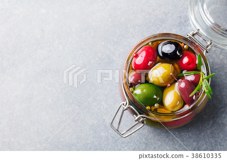 Olives assortment in glass jar with oil. Top view Olives assortment in glass jar with oil. Top view 38610335