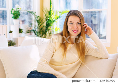 Young woman relaxing on a couch Young woman relaxing on a couch 38610899