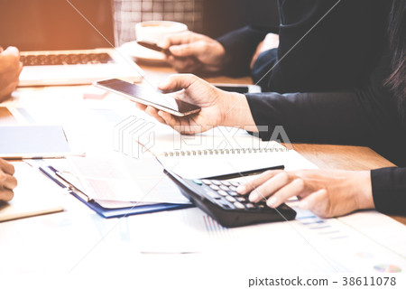 Business partners and teamwork discussing graph of 38611078