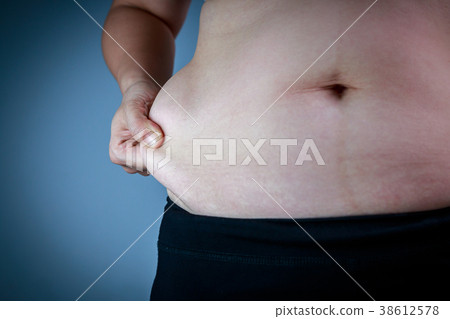 Woman checking fat on abdomen. Overweight concept Woman checking fat on abdomen. Overweight concept 38612578