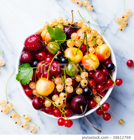 Assortment of fresh berries in white bowl Top view 38612799