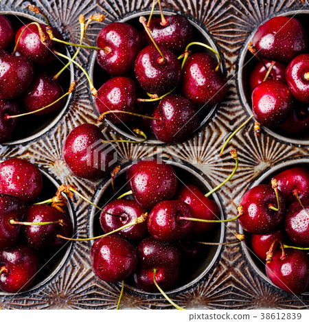 Fresh ripe black cherries in vintage dish Top view 38612839