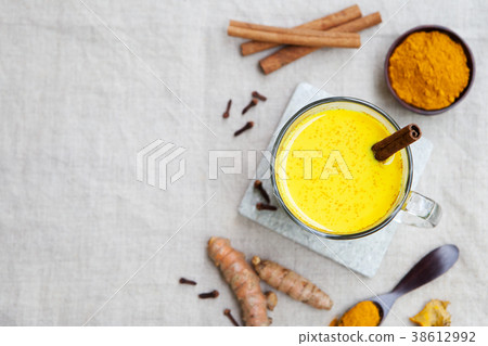 Turmeric drink, latte, tea, milk with cinnamon 38612992