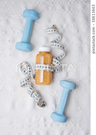 Detox drink with dumbbells and measuring tape Detox drink with dumbbells and measuring tape 38613603
