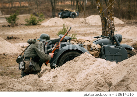 Wehrmacht's footman in cover behind a motorcycle 38614110