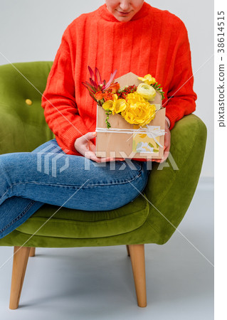 Woman holding giftbox with flowers and sweets 38614515