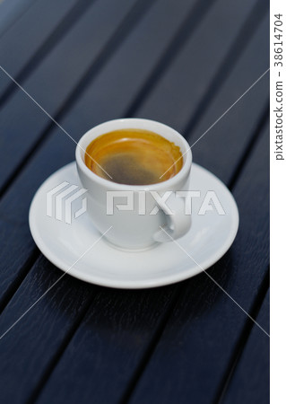 White coffee cup on black wood table background 38614704