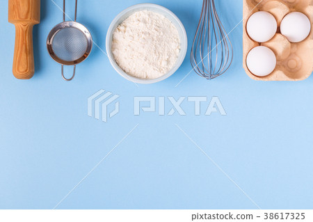 Ingredients for baking on a blue background. Ingredients for baking on a blue background. 38617325