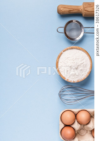Ingredients for baking on a blue background. Ingredients for baking on a blue background. 38617326