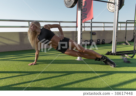 Young woman doing exercise strap in sportswear. Young woman doing exercise strap in sportswear. 38617448