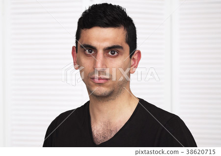 Young serious arabic man looking at camera Young serious arabic man looking at camera 38620715