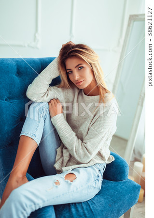 Portrait of pretty blonde woman sits on a chair. 38621127