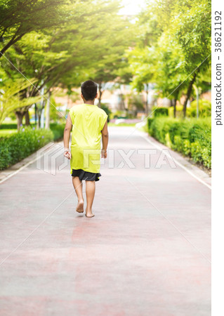 Rare view of young asian boy run in garden. 38621192
