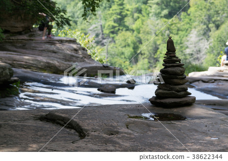 Pile of rocks by a waterfall Pile of rocks by a waterfall 38622344