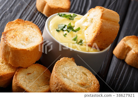 cheese dip sauce with toasted bread close-up cheese dip sauce with toasted bread close-up 38627921
