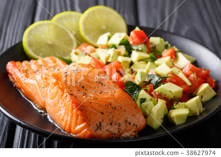 Fried salmon steak with avocado tomato salsa 38627974