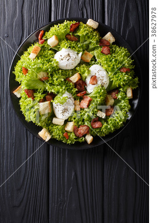 Gourmet salad Lyonnaise with lettuce, crispy bacon 38627978