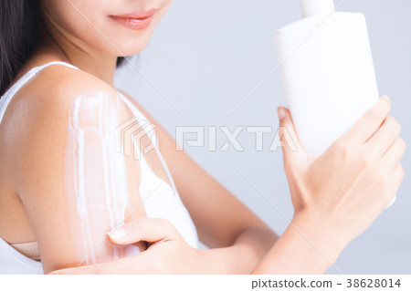 A woman is applying lotion. A woman is applying lotion. 38628014