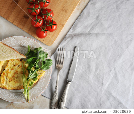 omelette on a plate, parsley, tomatoes, toast 38628629