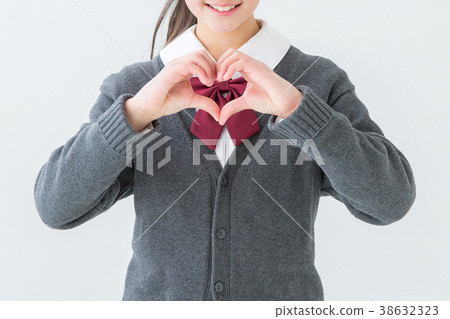 Girl in uniform making a heart symbol Girl in uniform making a heart symbol 38632323