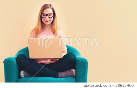 Young woman using her laptop computer Young woman using her laptop computer 38633400