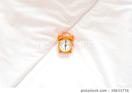 Orange Alarm clock get up six clock on bed 38633736