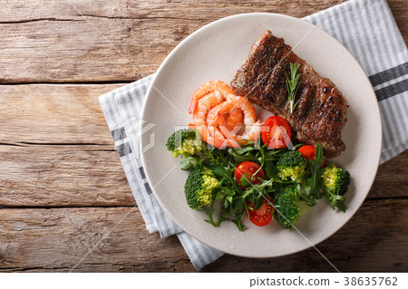 Delicious juicy barbequed steak and prawns Delicious juicy barbequed steak and prawns 38635762