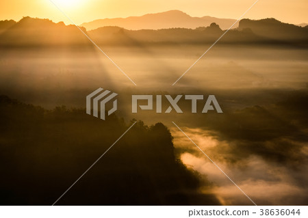 Golden sunrise shine on mountain in fog valley Golden sunrise shine on mountain in fog valley 38636044