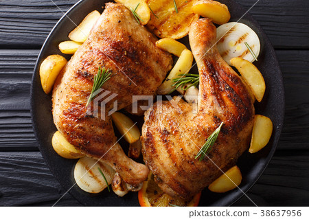 grilled chicken leg with orange, onions and potato 38637956