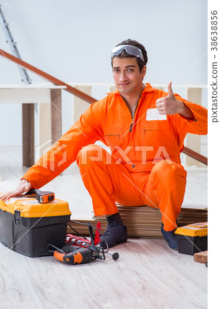 Contractor working on laminate wooden floor Contractor working on laminate wooden floor 38638856