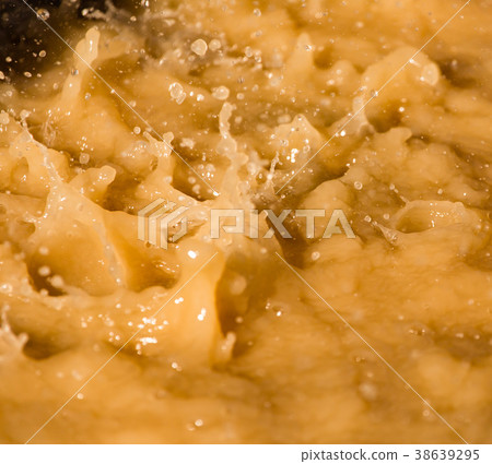 Rain drops fall into a dirty puddle Rain drops fall into a dirty puddle 38639295