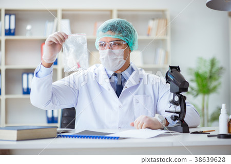 Forensics investigator working in lab on crime 38639628