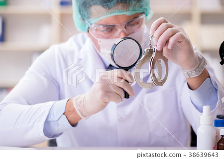 Criminologist police chemist looking at crime 38639643