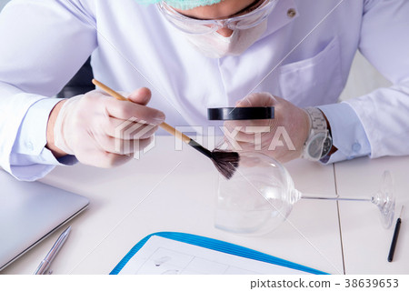 Criminologist police chemist looking at crime 38639653