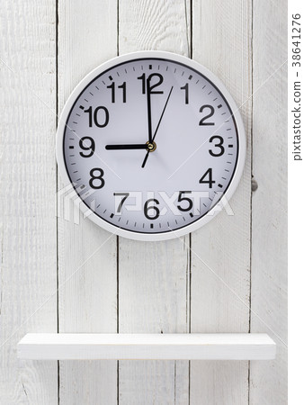 wall clock at wooden shelf 38641276