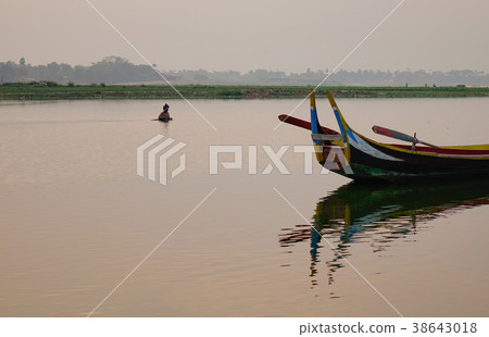 Wooden boats on lake in Mandalay, Myanmar Wooden boats on lake in Mandalay, Myanmar 38643018