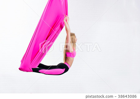 beautiful young girl antigravity yoga on a pink 38643086