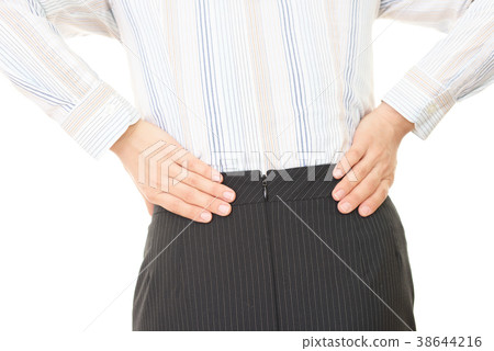 A woman complaining of low back pain A woman complaining of low back pain 38644216