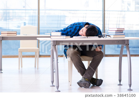 Student studying in the empty library with book Student studying in the empty library with book 38645100