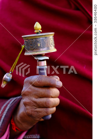A traditional Buddhist prayer wheel in the hand A traditional Buddhist prayer wheel in the hand 38646480