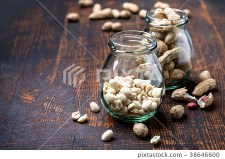 Peanut snack in jar on dark background 38646600