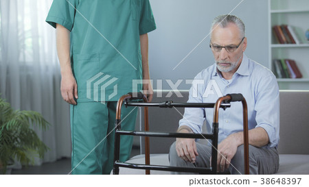 Depressed pensioner sitting on couch and looking 38648397