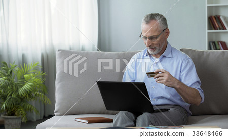 Attentive senior man sitting on couch and Attentive senior man sitting on couch and 38648466