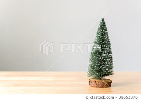 Christmas tree on wood table with white wall Christmas tree on wood table with white wall 38653370