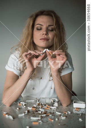 Smiling lady dropping her harmful habit 38654668