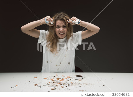 Angry woman trying to quit smoking 38654681