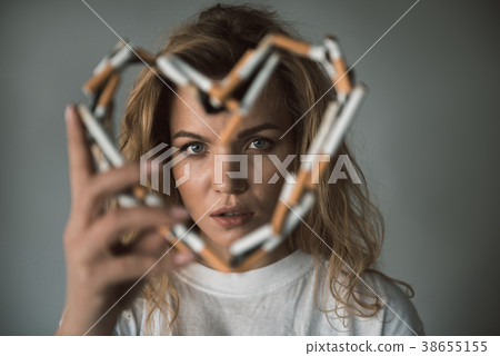 Calm woman being fond of fuming Calm woman being fond of fuming 38655155