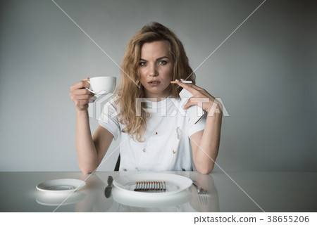 Nicotine abused woman drinking beverage 38655206